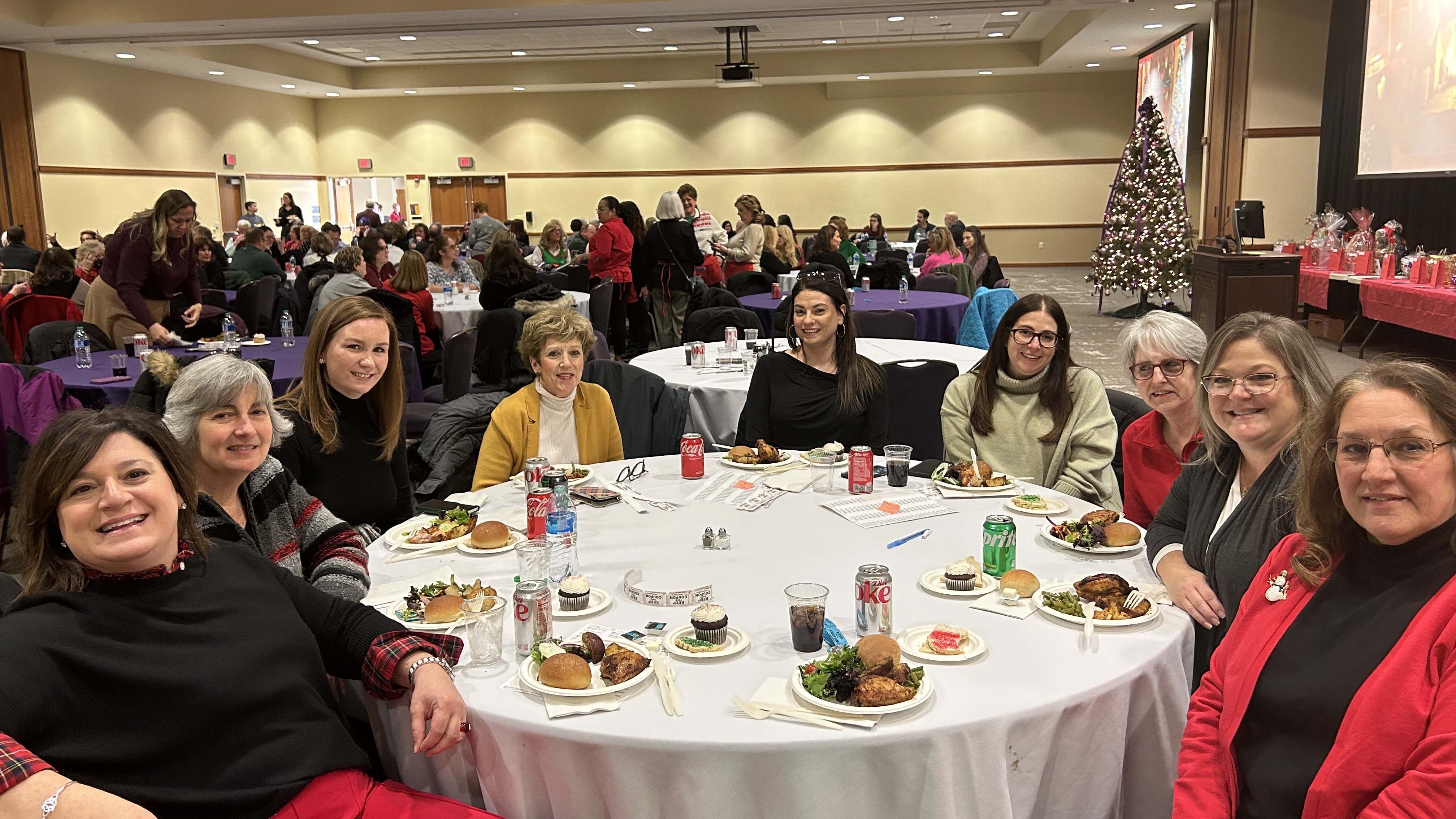 Shown, clockwise from left, are: Melinda Finnerty, Lori Flynn, Ellen Reagan, Sheila Strickland, Sandra Littzi, Aubree Armezzani, Geri Barber, Traci Vennie, and Lucy Grissinger. They were among the more than 350 who attended at the Staff Senate Christmas Luncheon hosted Wednesday, Dec. 14 in The McIlhenney Ballroom of The DeNaples Center. 