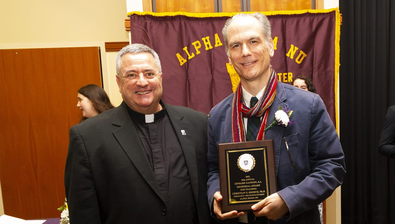 University of Scranton President Rev. Joseph Marina, S.J., congratulates Christian S. Krokus, Ph.D., professor of theology and religious studies, on receiving the 2023 Gannon Award for Teaching. University student members of Alpha Sigma Nu, the national honor society for students in Jesuit colleges and universities, select the professor to be honored.