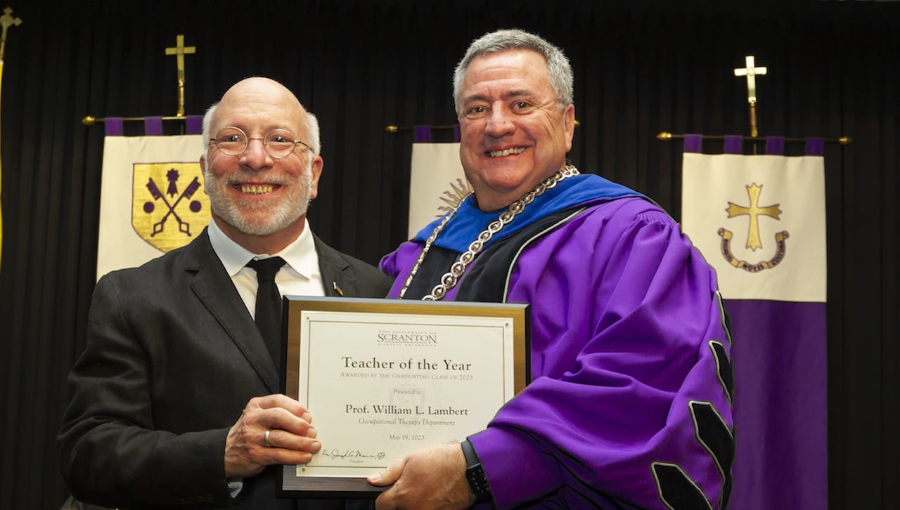 The University of Scranton’s graduating class of 2023 named William Lambert, faculty specialist for occupational therapy, as Teacher of the Year. From left, Prof. Lambert and University of Scranton President Rev. Joseph Marina, S.J., at the Teacher of the Year award presentation at Class Night.