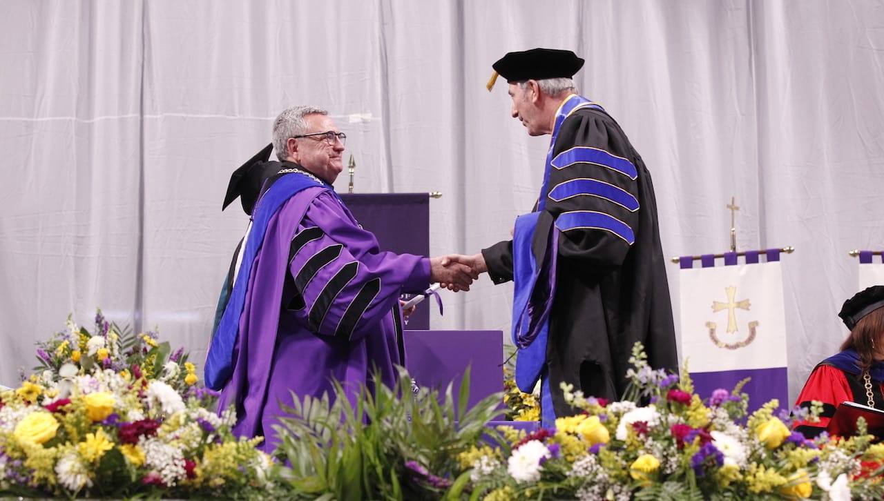 At the ceremony, the University conferred its first doctor of philosophy (Ph.D.) in accounting degrees. Andrew Gregorowicz of Jessup (right) receives his Ph.D. degree from University of Scranton President Rev. Joseph Marina, S.J. 