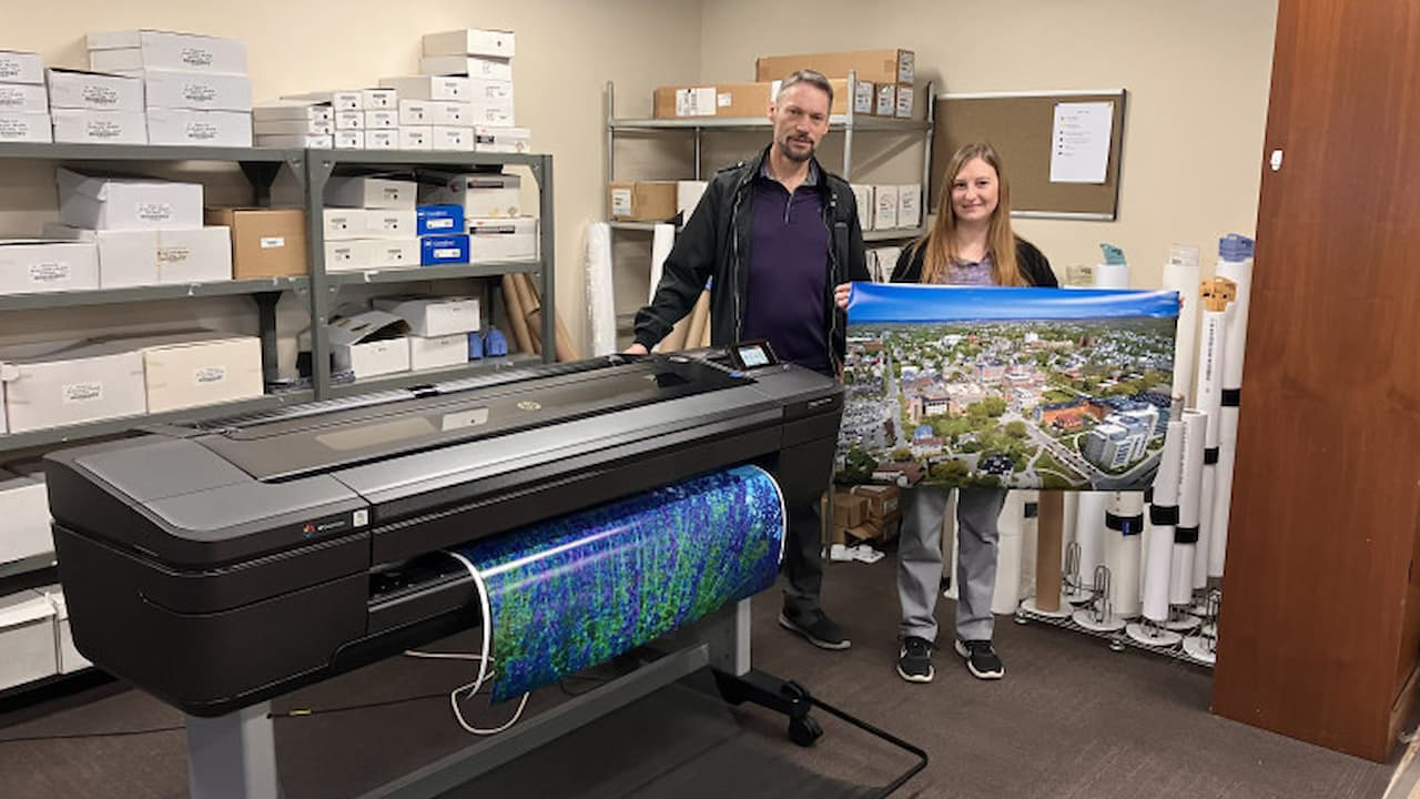 Assistant Director Michael Paolello and Digital Printing Operator Melissa Sherrill show off colorful prints produced by The University of Scranton Printing and Mailing Services’ new HP DesignJet Z9+.