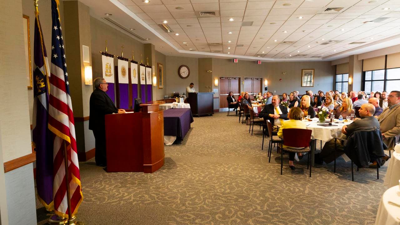 At The Order of Pro Deo et Universitate event in April, Rev. Joseph G. Marina, S.J., University president addresses inductees along with their families and friends in attendance.