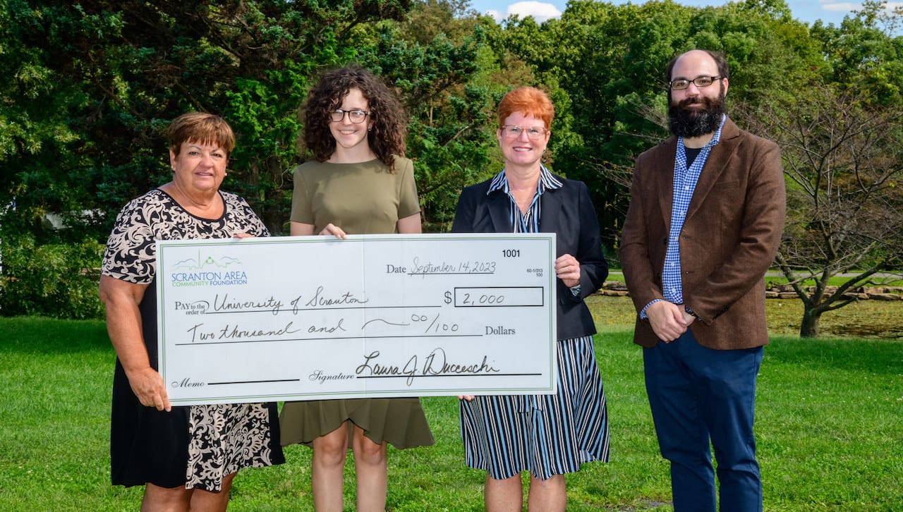 The Scranton Area Community Foundation awarded a $2,000 critical needs grant to support The University of Scranton Community English as a Second Language (ESL) Program. The grant will be used to purchase textbooks and workbooks to expand the capacity and improve the quality of the program through audio and video content, as well as reading and writing exercises. From left: Cathy Fitzpatrick, grants and scholarships manager; Scranton Area Community Foundation; Hannah Grijincu, director of the Language Learning Center; The University of Scranton; Meg Hambrose, director of corporate and foundation relations; The University of Scranton; and Frank Caputo, grants and communications coordinator; Scranton Area Community 