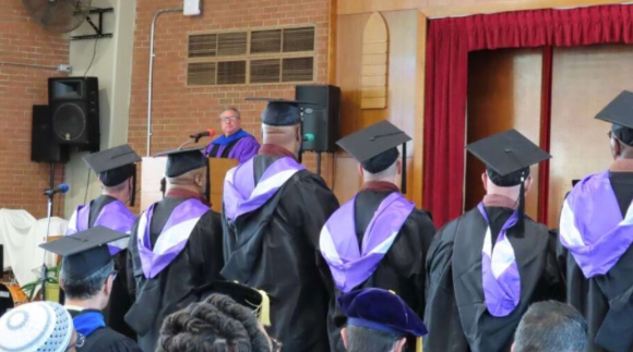 The Sunshine Lady Foundation will provide a total of $80,000 over a two-year period to The University of Scranton’s Prison Education Program at Dallas State Correctional Institution. The program provides an opportunity for incarcerated individuals to earn an Associate of Arts degree in Liberal Studies from the University by participating in courses offered at the facility by Scranton professors. Pictured, University of Scranton President Rev. Joseph G. Marina, S.J., addresses the first cohort of nine graduates of the program at a commencement ceremony held at Dallas SCI in December 2023.