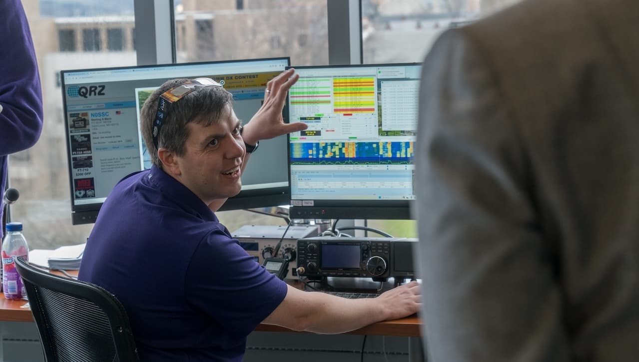 The University of Scranton will dedicate its state-of-the-art amateur radio station W3USR, which is located on the fifth floor of the Loyola Science Center, at a ceremony that begins at 3:15 p.m. on Friday, Oct. 25. The event will include an open house for the station, a reception with light refreshments, a display of student research posters and a presentation by Nathaniel Frissell, Ph.D., associate professor of physics and engineering at Scranton, and student members of W3USR: The University of Scranton Amateur Radio Club. Pictured is Dr. Frissell in the main amateur radio station, conducting research during the solar eclipse as part of a NASA space research project.
