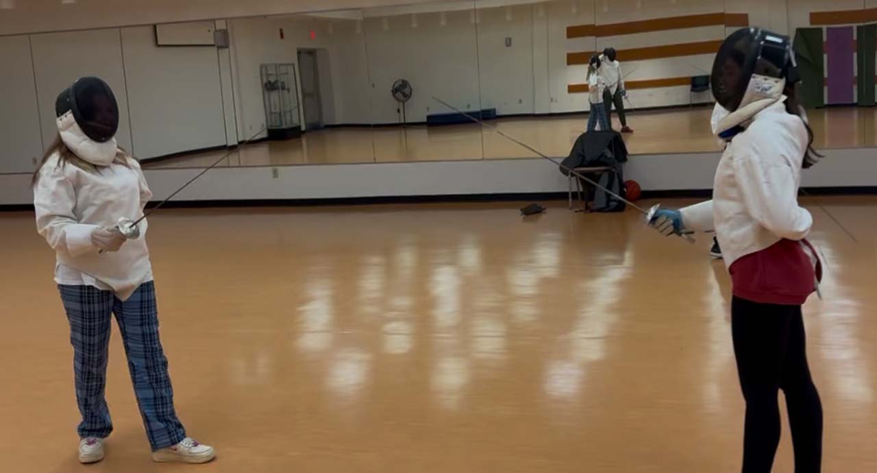 Shown, Fencing Club Vice President / Co-chair Morgan Masters, left, and Ava Dunham, club member.