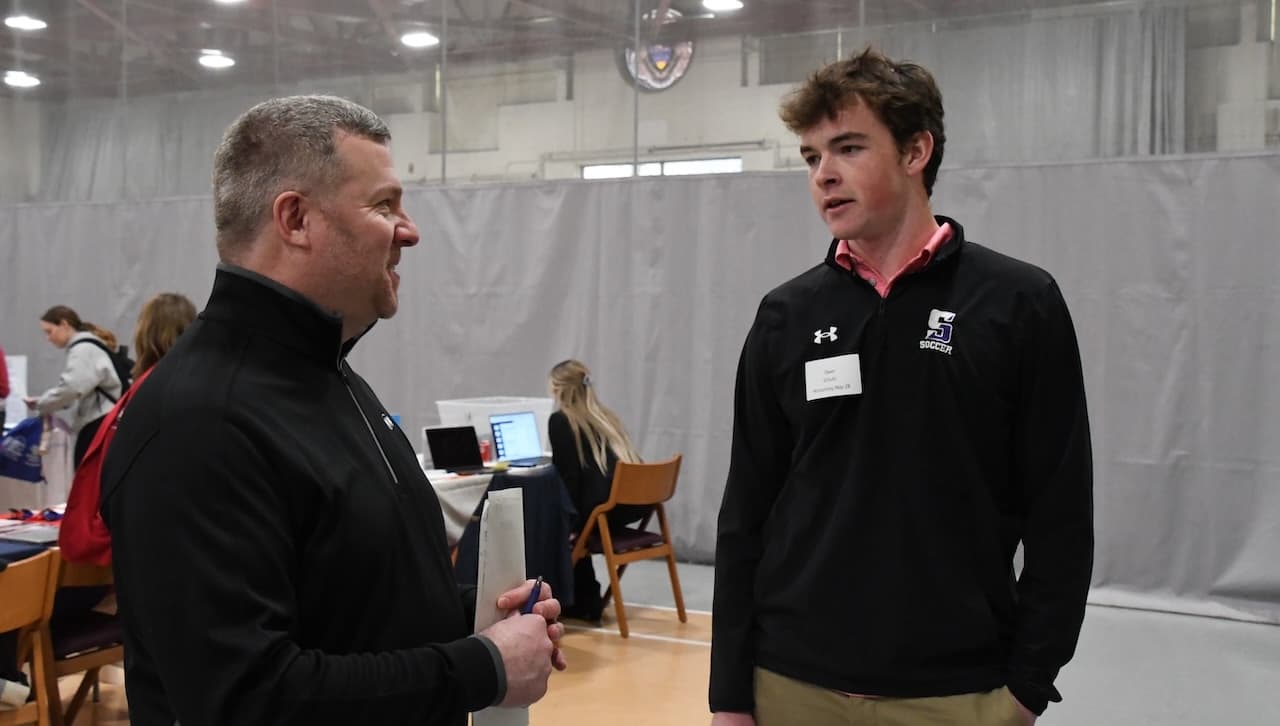University of Scranton alumnus Paul Ursich ’95, left, Partner, Wiss and Company, speaks with first-year student Owen Schultz, an accounting major, at the Spring 2025 Career Expo. Hundreds of students participated in the event.