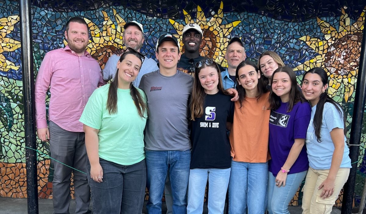 students and chaperones in front of mosaic wall