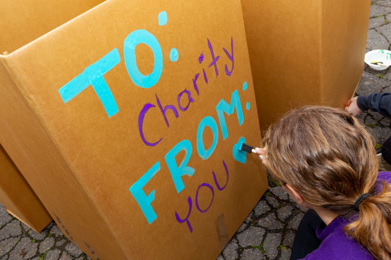 Volunteers prepare for the end-of-the-year drive collection with boxes, paint and creative messaging. Shown, 2023 student volunteers.