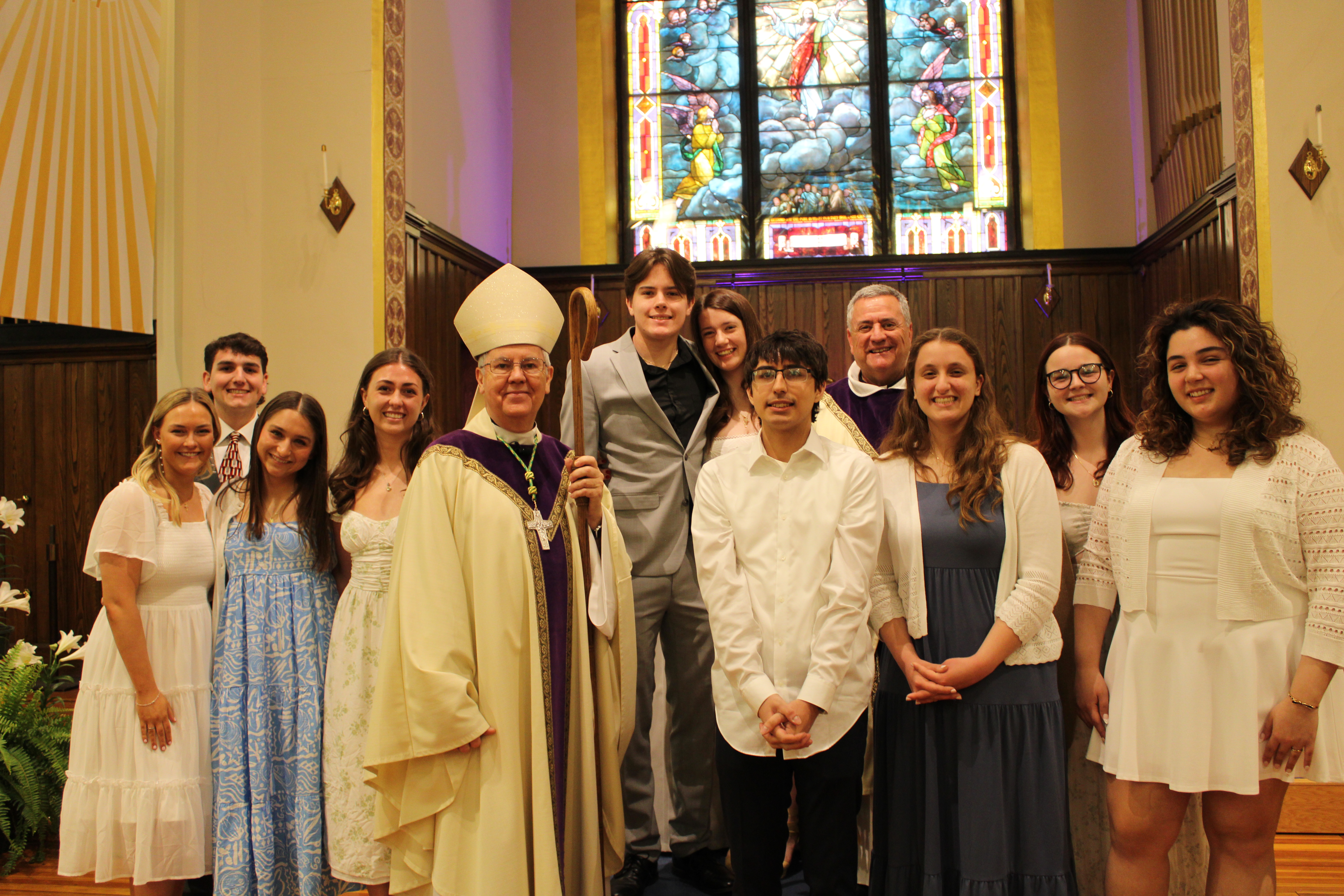 Five University of Scranton students in the Order of Christian of Initiation of Adults recently completed their initiation into the sacramental life of the Catholic church. Shown, the students with sponsors, from left: Sara Tully '27, Daniel Patrick Hunt, Jr. ’27, sponsor; Megan Davis ’27, sponsor; Cristiana Basile '27, Most Reverend Joseph C. Bambera, D.D., J.C.L., Bishop of the Diocese of Scranton; James Detwiller, sponsor; Riley Struble '28, Jackson Conti '27, Fr. Marina, Cara Galli ’25, sponsor; Ella Beckerich ’28, sponsor; Sophia Carranza '28.