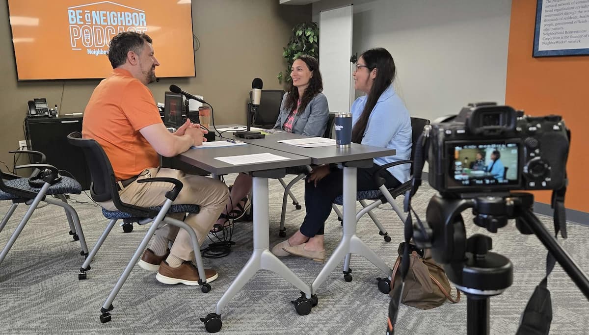 three people in a studio with microphones