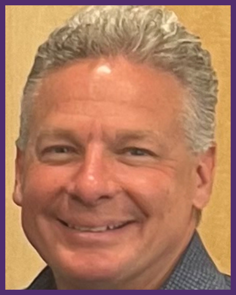 a portrait headshot of an individual, smiling