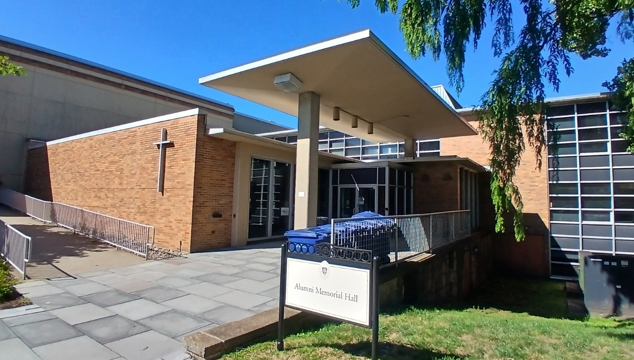 Exterior view of Alumni Memorial Hall showcasing its modern architecture and landscaping.