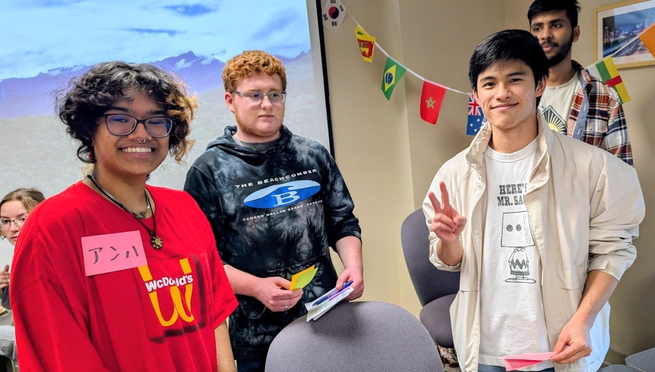 Students pick up a few words—and some new friends—at the Japanese language and culture station during the Department of World Languages and Culture’s 2025 Fall Open House on Monday, Oct. 6. Pictured left to right: Haley Fahey, Nurun Islam, Dominic A. Liberatore Jr., Itsuki Yajima, and Nisarg Modi. (Photo courtesy Dr. Amy Kuiken)