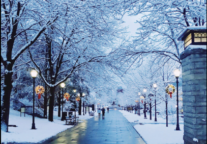 evening snowy scene on University campus with wreaths on lampposts