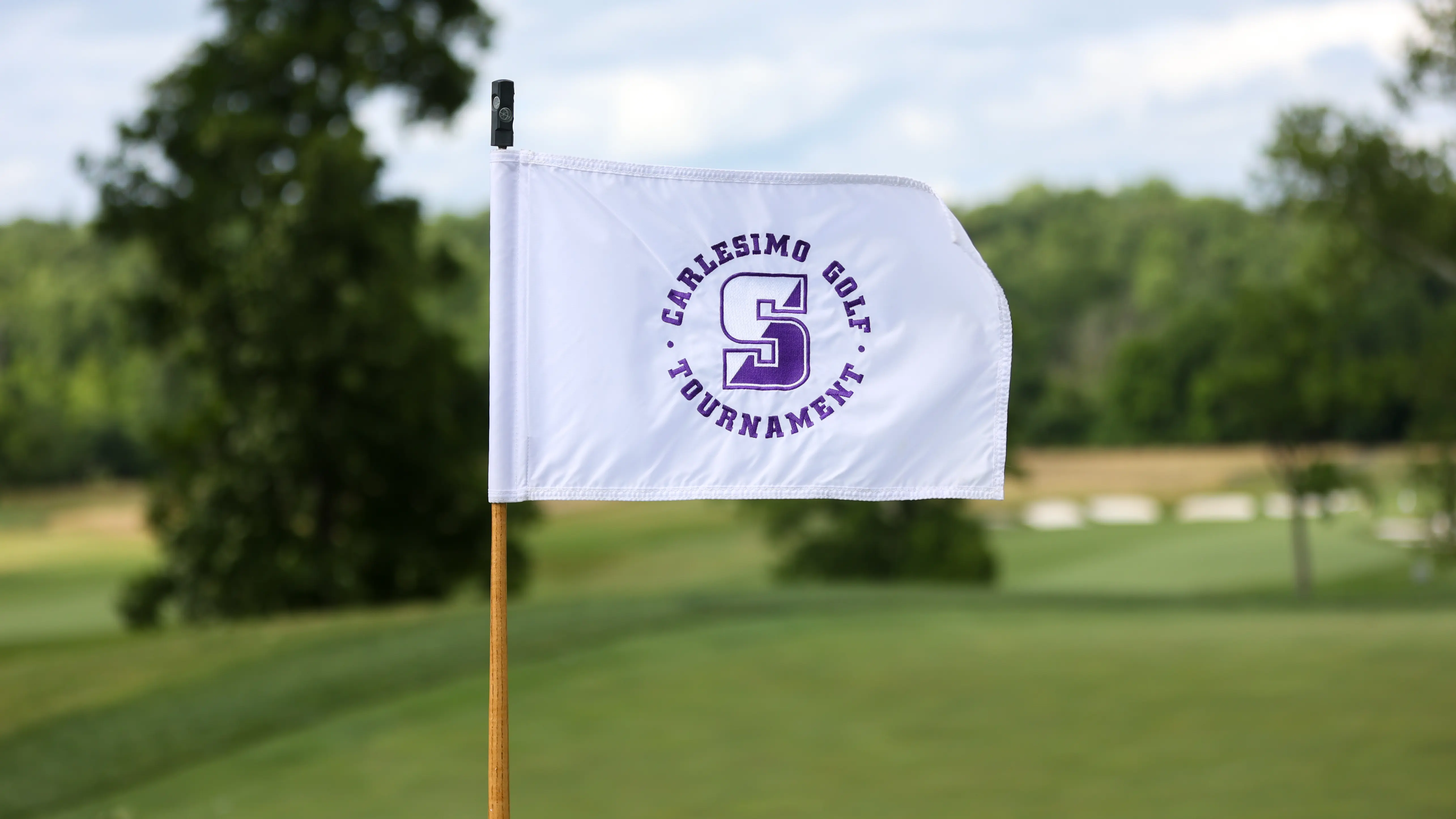 The Carlesimo Golf Tournament & Award Dinner flag flies high.
