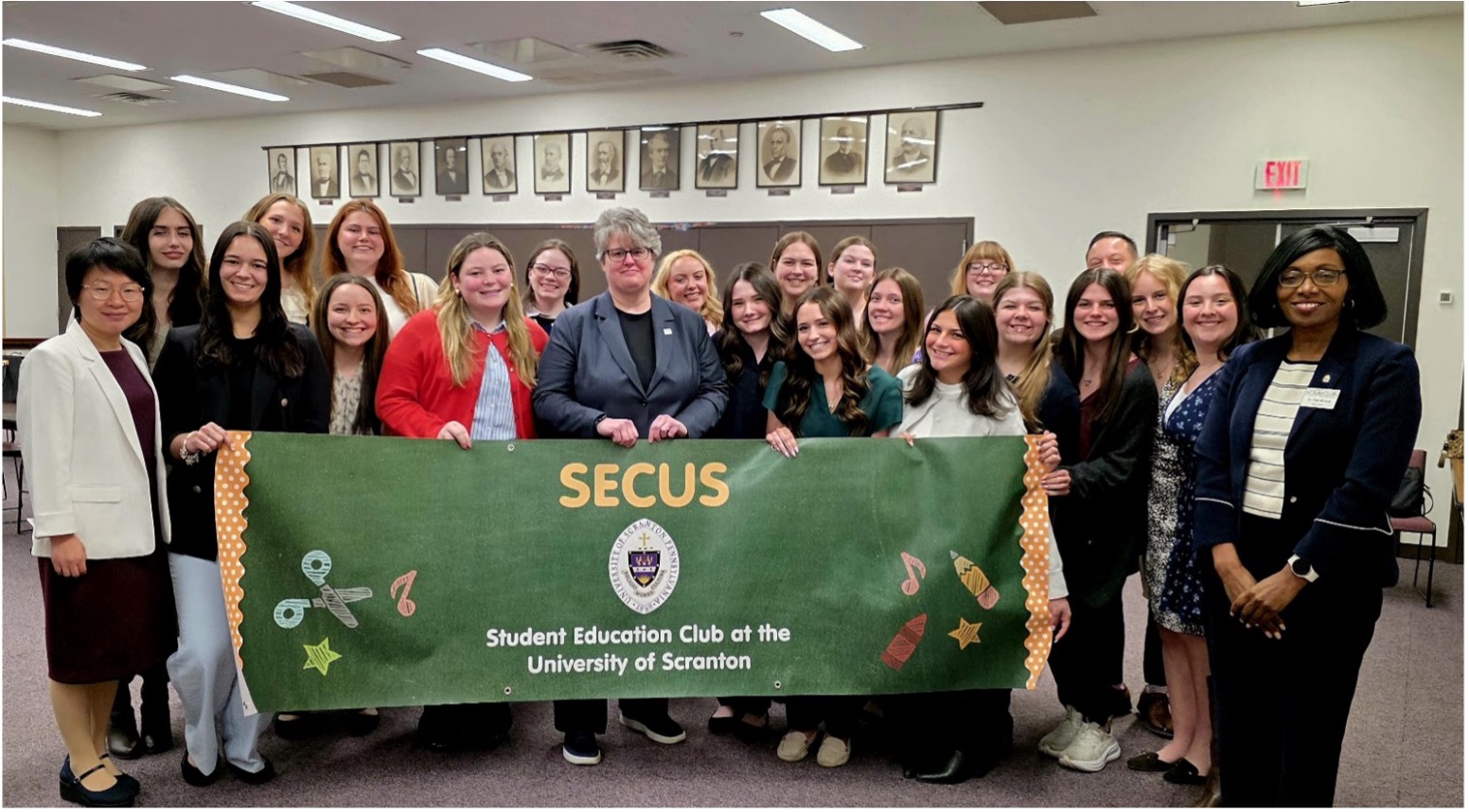 Dr. Carrie Rowe, Secretary of Pennsylvania Department of Education (center) is shown with students and professors representing The University of Scranton.