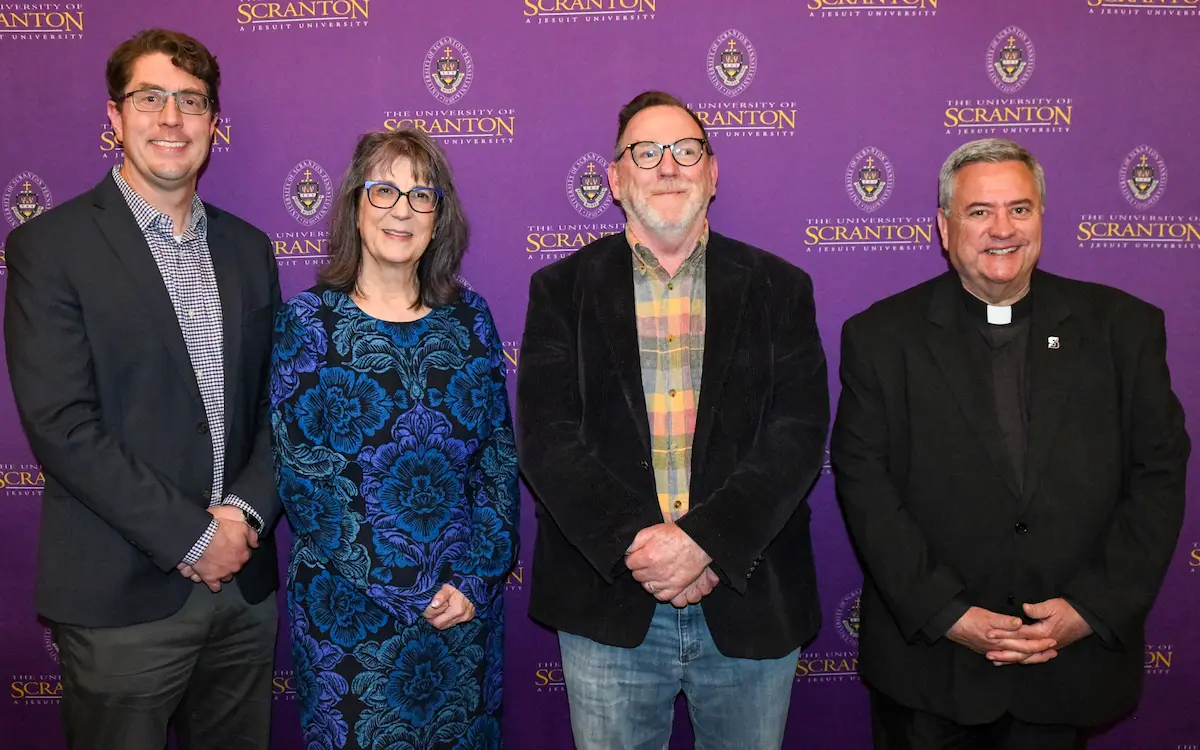 A gallery of images of individuals posing for photos in front of a purple, University of Scranton-branded backdrop.