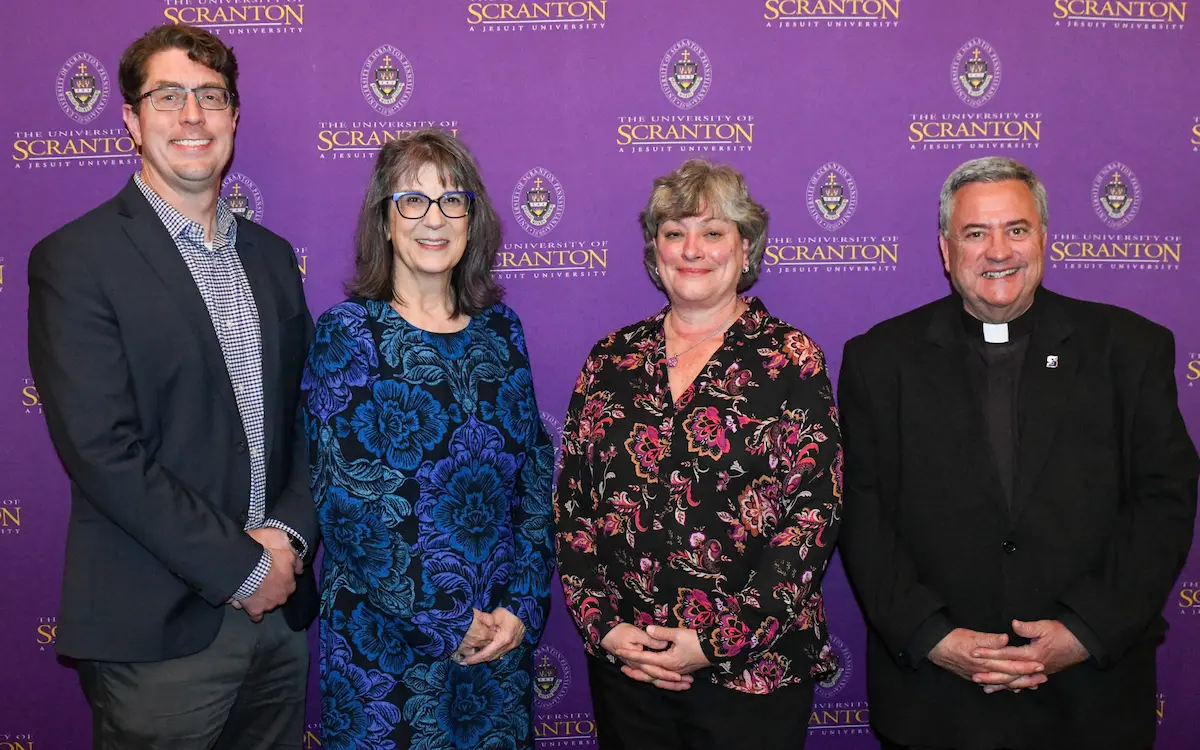 A gallery of images of individuals posing for photos in front of a purple, University of Scranton-branded backdrop.