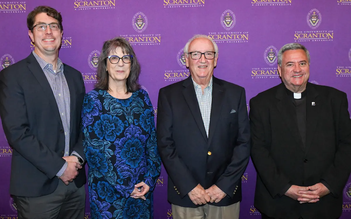 A gallery of images of individuals posing for photos in front of a purple, University of Scranton-branded backdrop.
