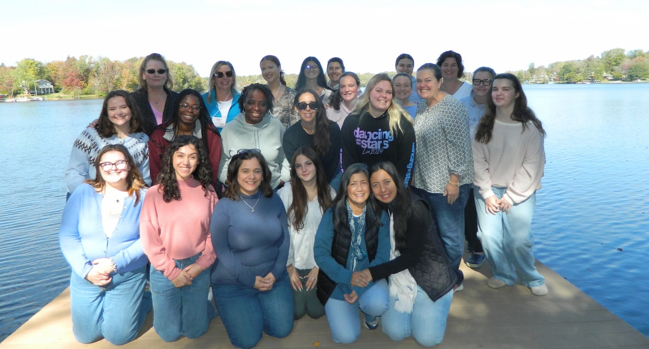 a group of women with a lake in the background