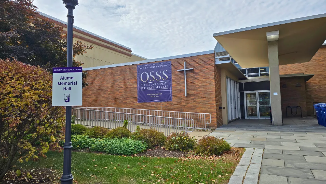photo of new OSSS signage on the side of brick building