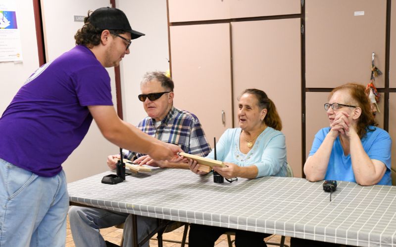 A gallery of images showing volunteers and Lackawanna Blind Association clients working together and celebrating their accomplishments.