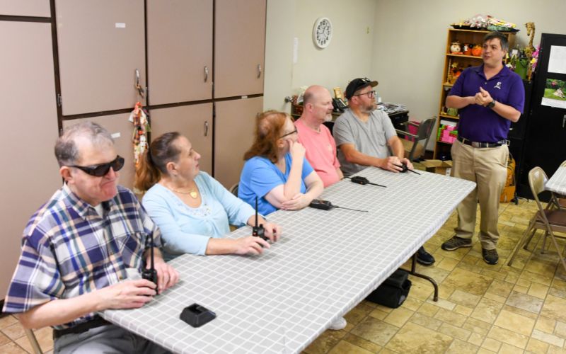 A gallery of images showing volunteers and Lackawanna Blind Association clients working together and celebrating their accomplishments.