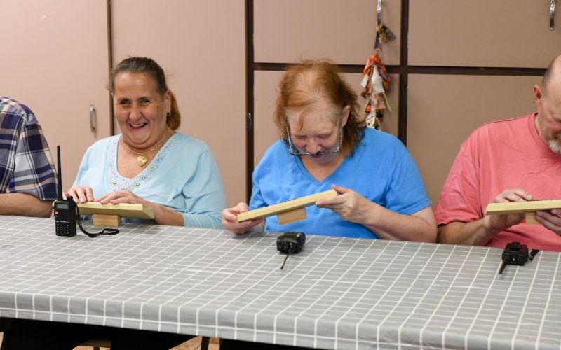 A gallery of images showing volunteers and Lackawanna Blind Association clients working together and celebrating their accomplishments.